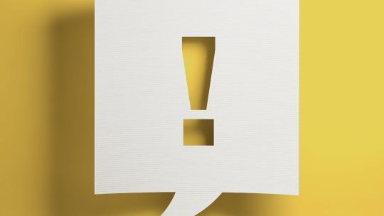 Exclamation mark against a yellow background
